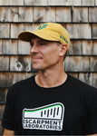 Yellow Nomad Ball cap with Green Nomad Wolf logo and Nomad text logo above right ear